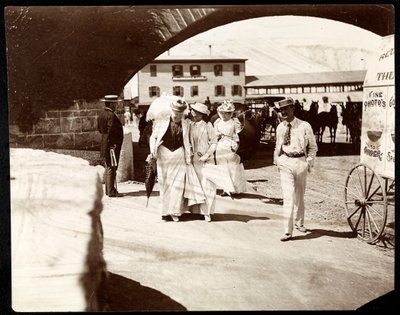 Three women and a man walking at the Narragansett Pier with itinerant photographer